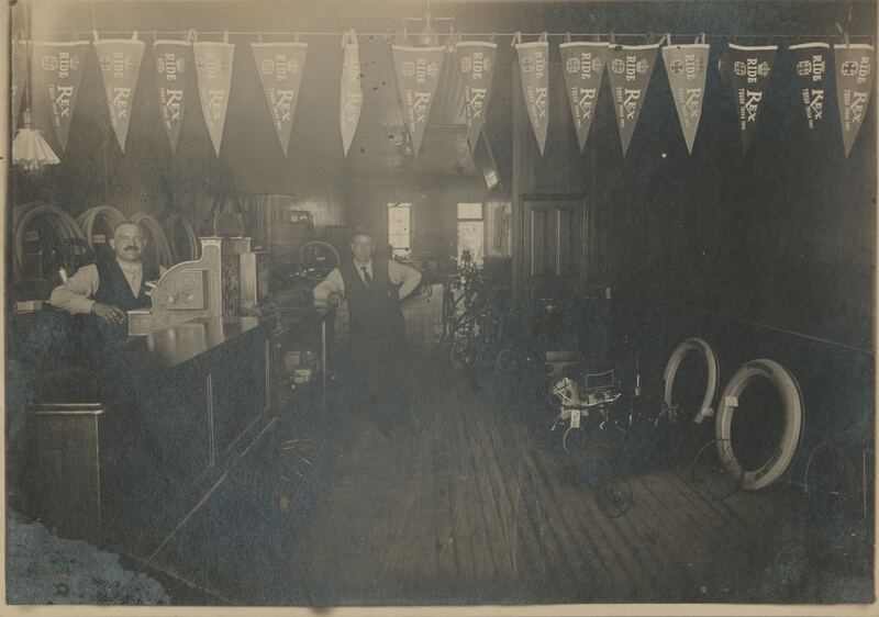 Photograph of John G. Krauss and Mr. Kraus at Kraus & Krauss, a bicycle shop.